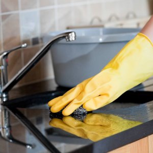 Close-up of a woman cleaning a kitchen at home